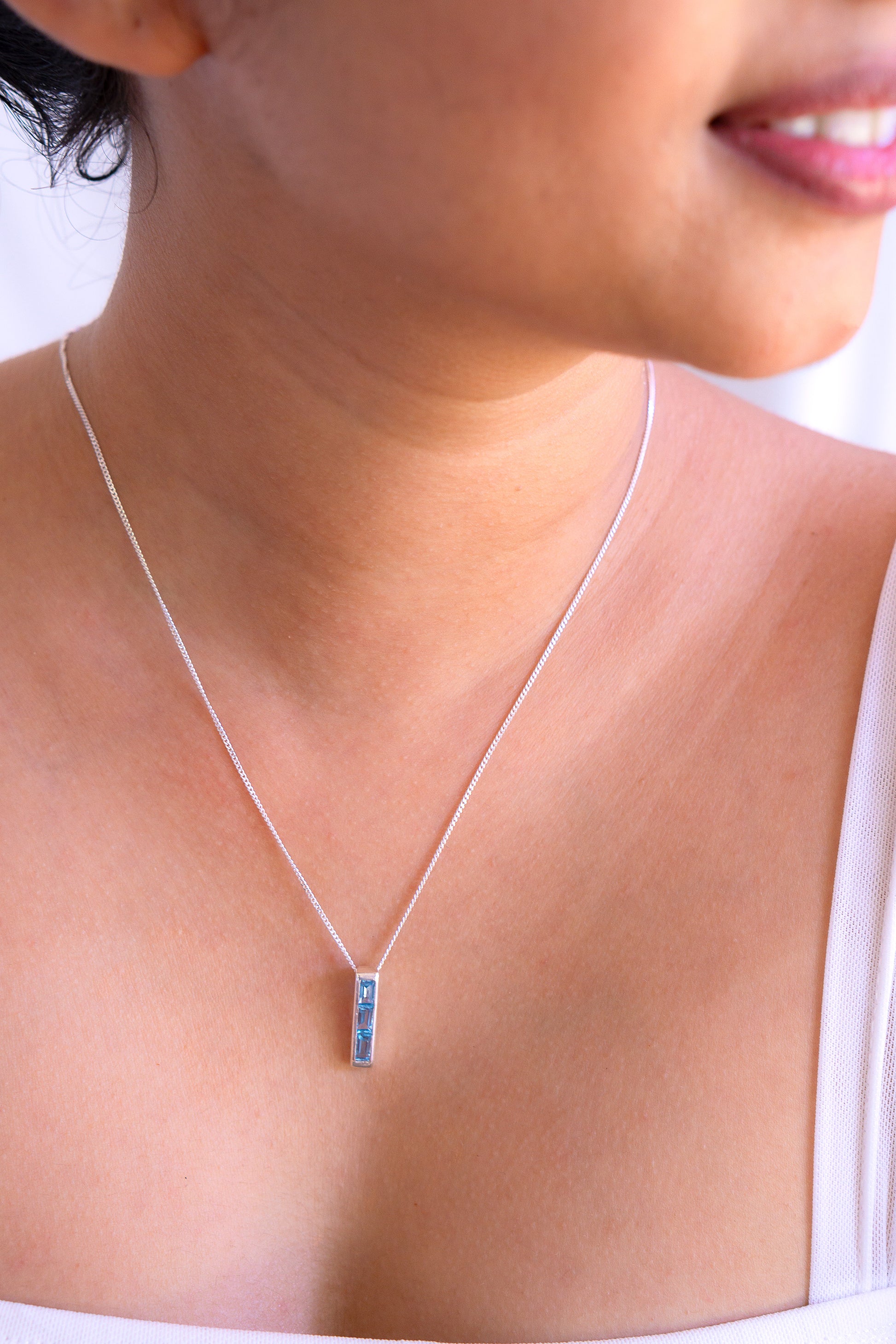 Sterling silver Arabella necklace with blue topaz gemstone pendant by Cherie Lueur